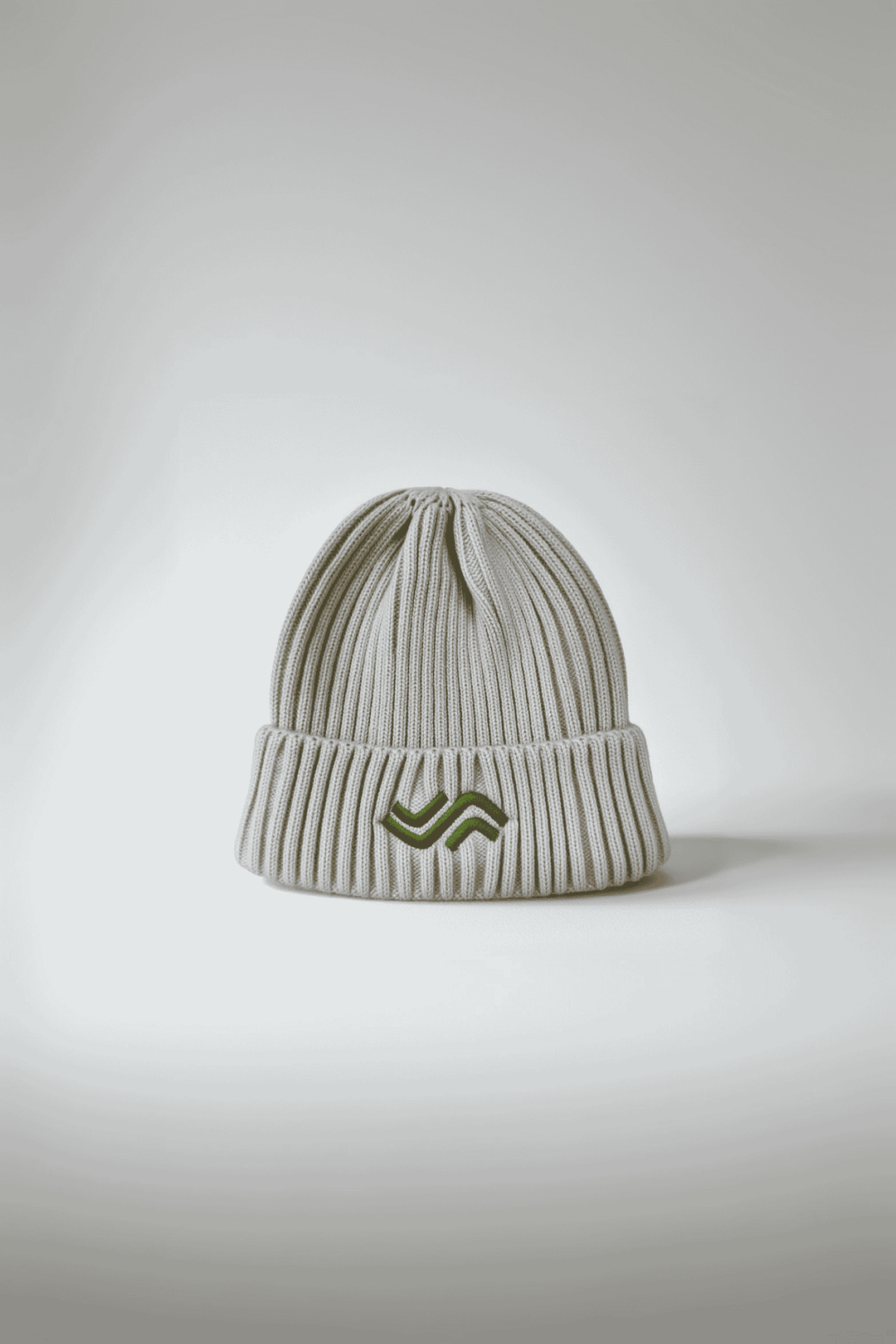 White knit beanie with a logo on a light gray background
